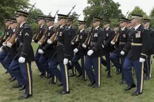 Soldiers of the 3rd U.S. Infantry Regiment march in formation at the Twilight Tattoo