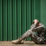 Frustrated Soldier leaning against a shipping container; Law Office of Peter Kageleiry. Jr. defends service members against Article 120 Sexual Assault allegations. assists with appeal Article 120 Sexual Assault conviction