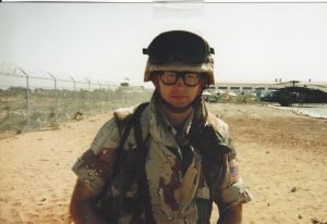 1LT Peter Kageleiry, Jr. facing the camera, stands on an airfield in Somalia 1993; experienced former JAG and experienced military lawyer.