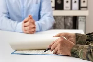 Service member signing a statement in a conference room with attorney; What to do if you are the subject of a command investigation
