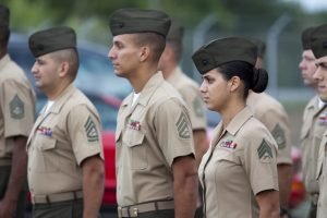 Marine Non-commissioned officers, oth male and female, stand in formation facing left of the photo in quantico, virginia; This article is about guilty of Article 120 sexual assault; accused of sexual harassment.